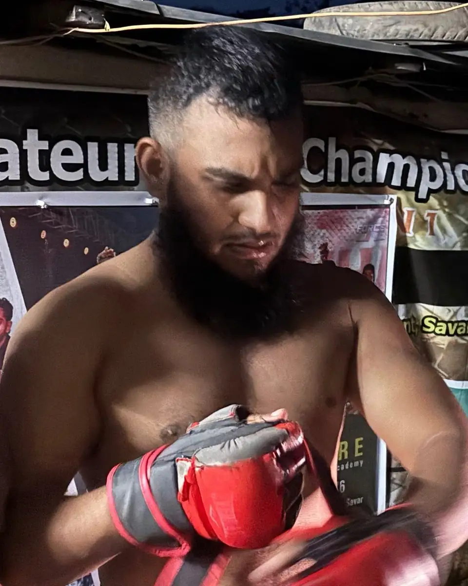 Before the fight: Meer wrapping up and putting on his gloves under the Amateur Championship banner